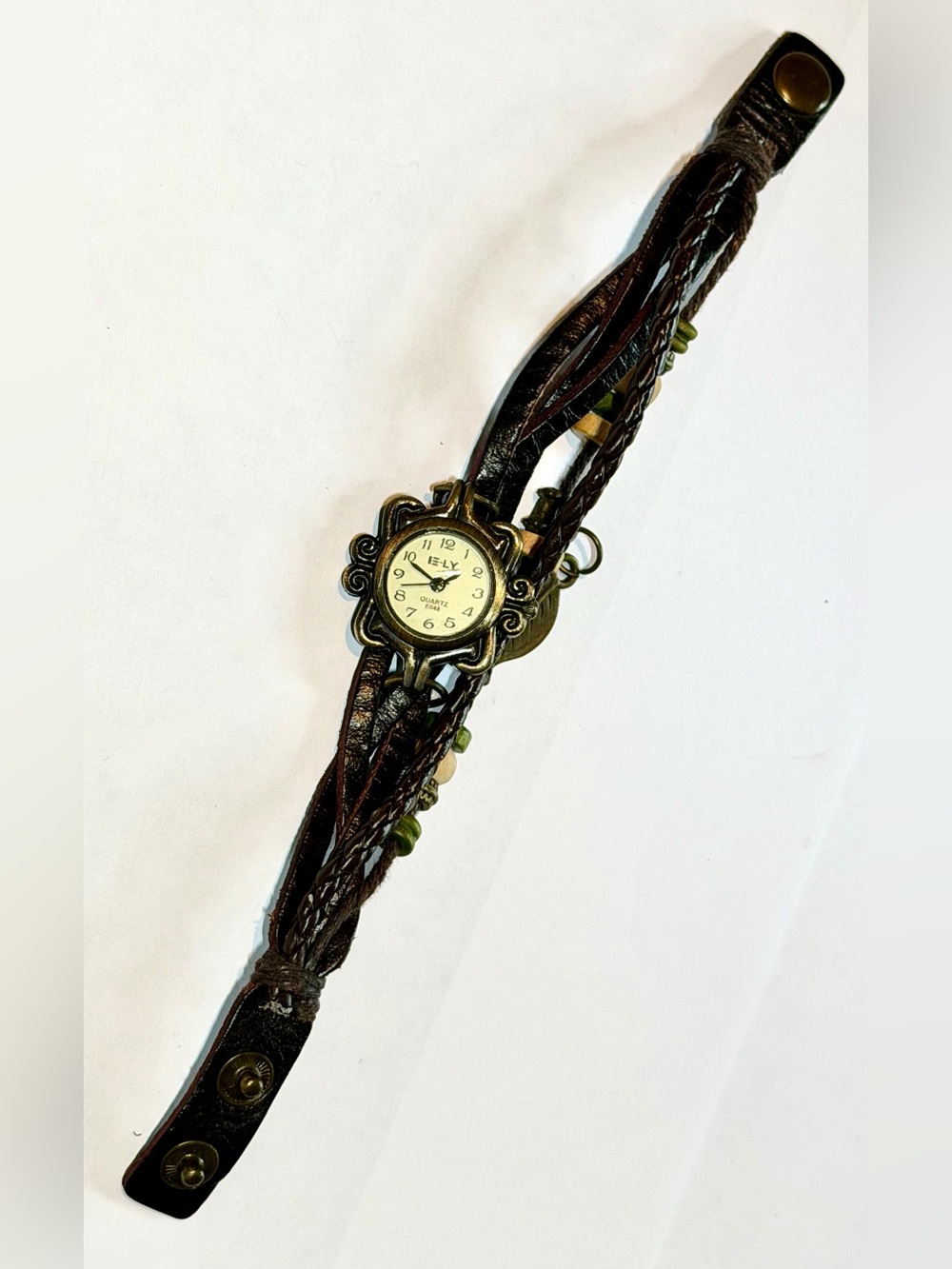 E-LY watch, multi-stranded leather band with “leaf” charm, purchased in Scotland